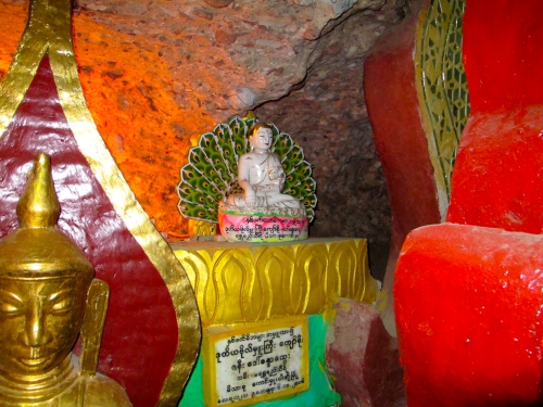 Caves are filled with thousands of shrines to Buddha, in a huge range of sizes and designs (most of them carved in and around Mandalay).This is a small one tucked away behind the base of a huge one.
