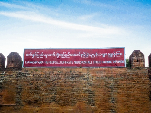 The Myanmar armed forces : TATMADAW by name, CRUSHING their game. This sign is on the wall of Mandalay's 1 mile square royal palace, now a military base.