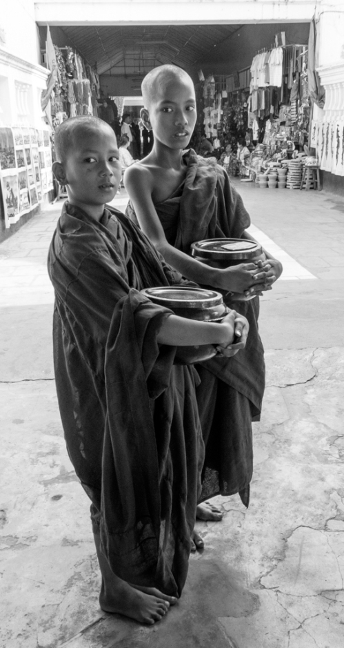 These young monks are collecting Dana, the gifts from the population on which the monks survive. Almost all Burmese boys will ordain for 2-4 weeks and be initiated into their Buddhist culture.